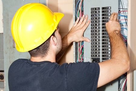 electrician working on a circuit breaker panel